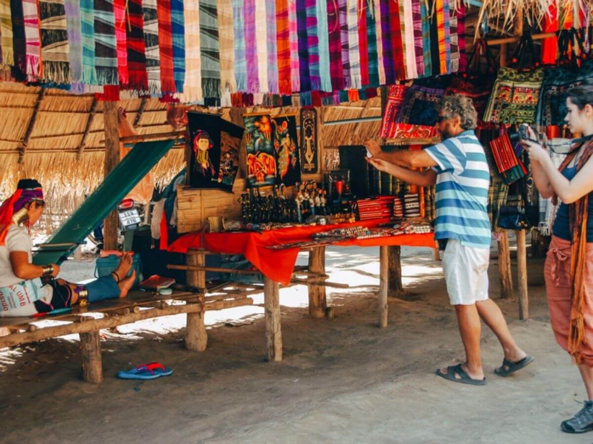 Travellers taking photos in a show village situation